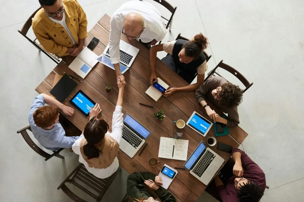 Illustrative business planning meeting with laptops